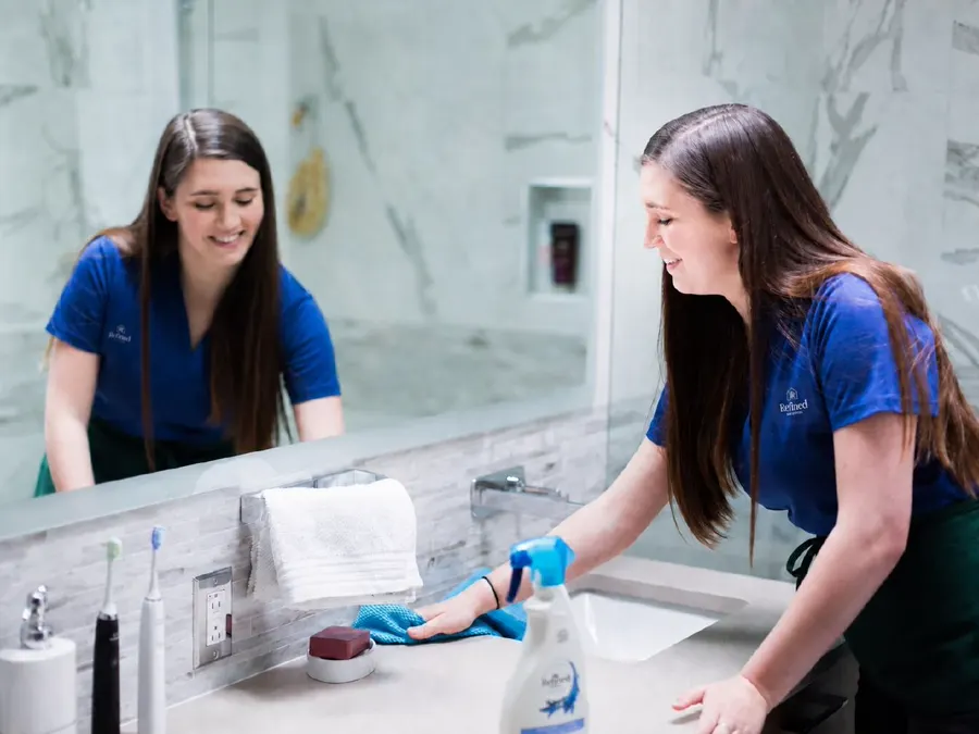 Refined Services Group cleaning professional working in a home
